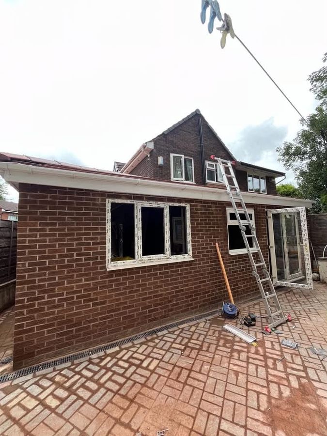 Single-storey rear extension nearing completion, with new block-paved patio