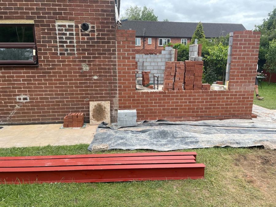 New garden wall under construction with steel lintels ready to install