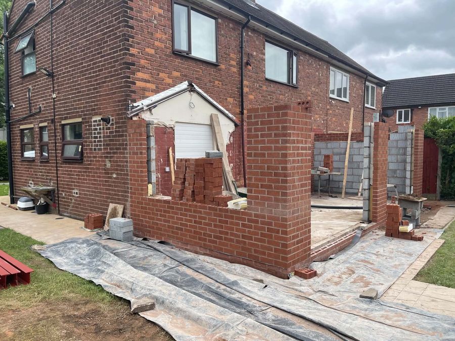 Brick piers and blockwork going up at the front of a house