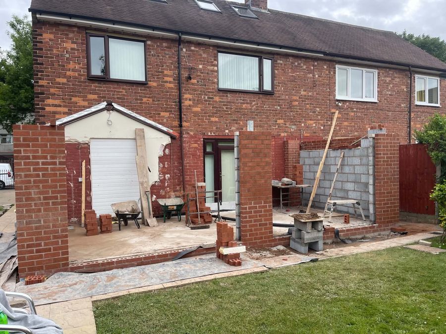 Front elevation with new brick piers and garage opening formed