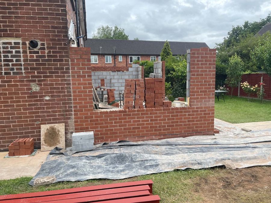 Blockwork and brick wall being built across a rear garden