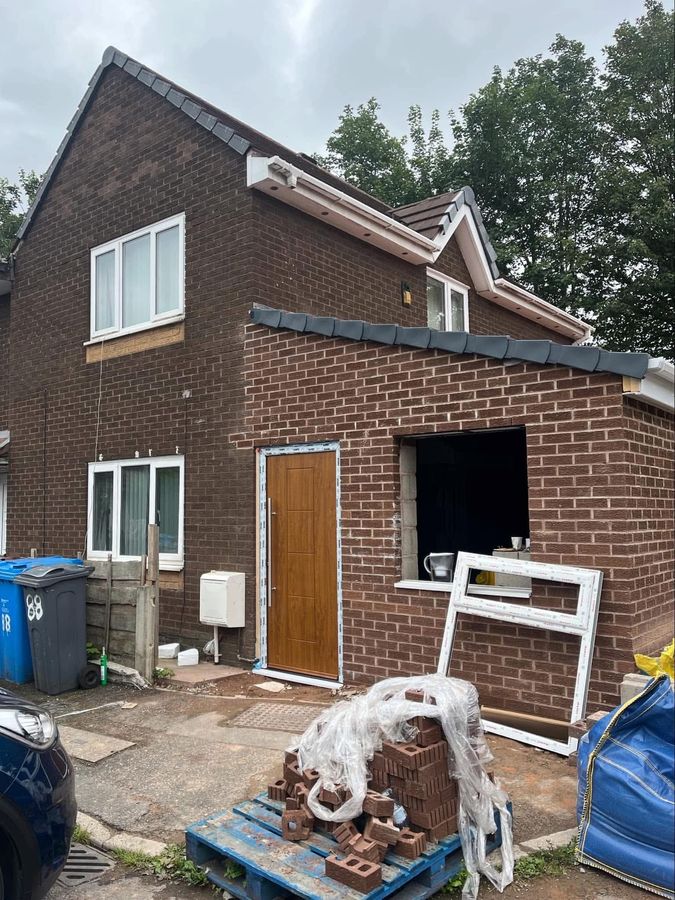 Garage conversion in progress, opening bricked up ready for new windows and doors